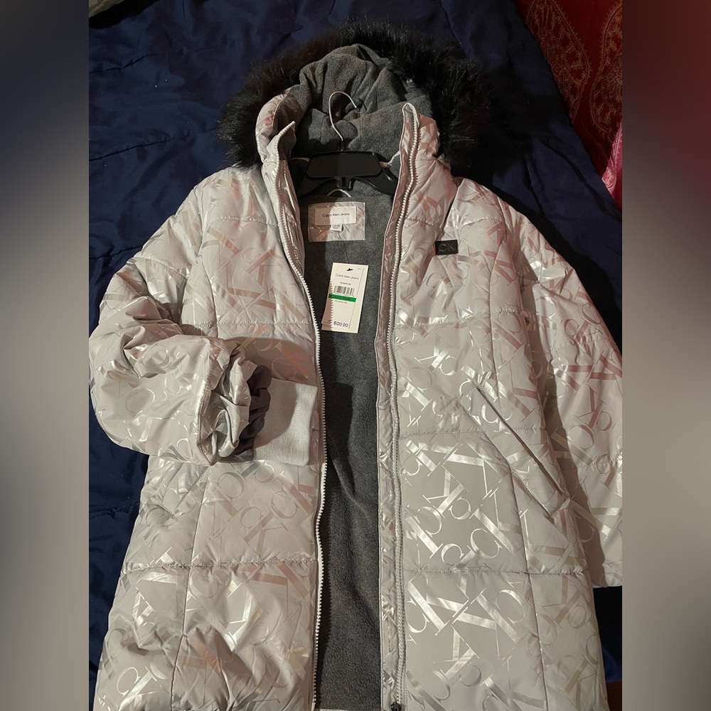 CK Winter puffy jacket. Grey color with CK logo pattern.